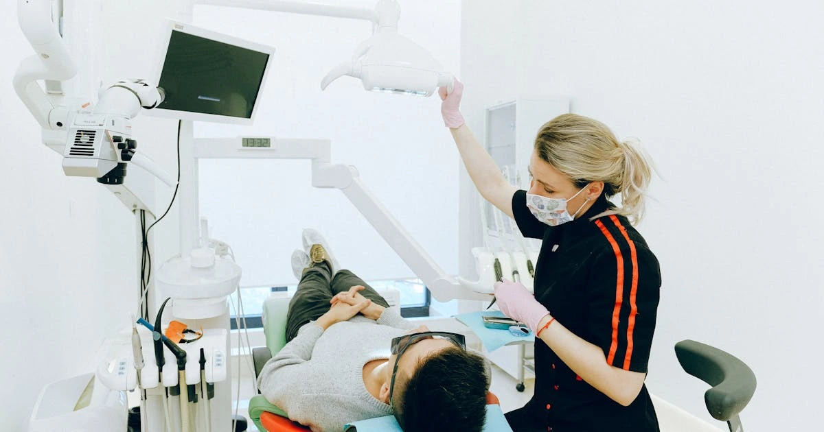 Dentista realizando limpeza profissional em consultório moderno